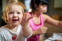 Happy smilling cute little girl pointing thowards the camera — Stock Photo