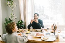 A family having breakfast together at the dining table in their home — Stock Photo