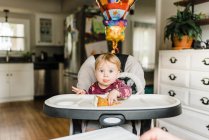 One year old celebrating birthday with family at table with cake — Stock Photo