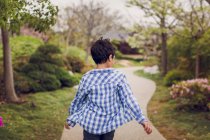 Young boy walking  in the park — Stock Photo