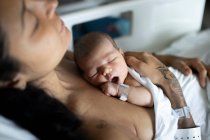 A newborn with her young mother in the hospital having a rest. — Stock Photo