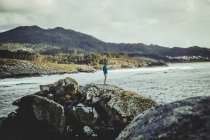 Young  man standing on the cliff — Stock Photo