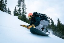 Man snowboarding on snowcapped mountain against sky during vacation — Stock Photo
