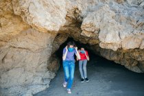 Teen Girl And Her Brother Put On Face Masks While Exiting A Sea Cave — Stock Photo