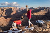 Young woman hiking with dog during vacation — Stock Photo