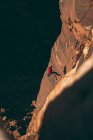 Vista de alto ângulo do homem escalando penhasco rochoso no Parque Nacional de Canyonlands — Fotografia de Stock