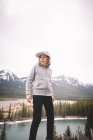 Donna in piedi con zaino su un paesaggio mattutino freddo. bella ragazza sta facendo escursioni in montagna — Foto stock