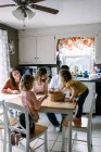 Сім'я з 5 розмальовок і проводити час разом за кухонним столом — стокове фото