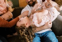 Joyeux jeune famille de cinq personnes riant et jouant ensemble à la maison — Photo de stock