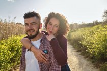 Portrait of happy couple walking in the countryside — Stock Photo