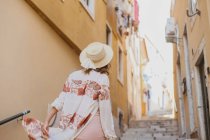 Beautiful young woman in straw hat — Stock Photo