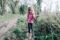 Young girl walking through a stream exploring whilst hiking in the UK — Stock Photo