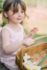 Маленькая девочка играет с деревянным столом — стоковое фото