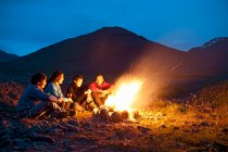 Amici seduti vicino al falò in Islanda — Foto stock