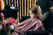 Little girl in the barbershop — Stock Photo