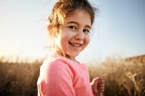 Close-up portrait of smiling girl hiking on sunny day — Stock Photo
