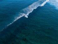 Повітряний вид на океан і серфер на фоні природи — стокове фото
