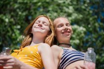 Two happy tween girls in swimsuits outdoors. — Stock Photo