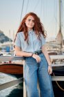 Portrait of a young redhead woman in a seaport of a city — Stock Photo