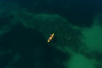 Aerial view to yellow kayak in the sea — Stock Photo