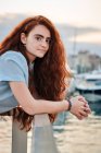 Portrait of a young redhead woman in a seaport of a city — Stock Photo