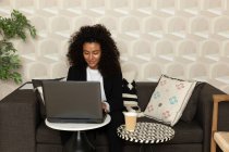 Mujer de negocios africana usando computadora portátil - foto de stock