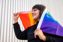 Portrait of a latina woman wearing the rainbow flag — Stock Photo