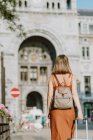 Young woman with suitcase walking in the city — Stock Photo
