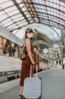 Junge Frau mit Koffer im Flughafen — Stockfoto