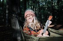 Mujer joven con guitarra en el parque - foto de stock