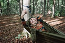 Young man with a backpack in the forest — Stock Photo