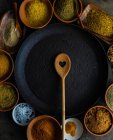 Variety of traditional georgian spices in bowls on wooden table — Stock Photo
