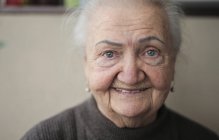 Portrait of elderly lady in her home — Stock Photo