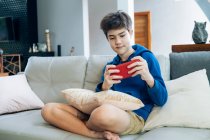 The boy playing online game on smartphone at home. — Stock Photo
