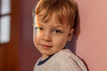 Portrait of a toddler boy with rainbow light on his right eye — Stock Photo