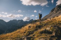 Man stops at the trail to admire the beauty of the Pyrenees mountains against cloudy sky, Aragon Spain — Stock Photo