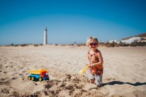 Criança brincando na areia na praia — Fotografia de Stock