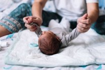 Mother exercising her baby's arms. — Stock Photo