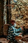 Авантюрный бородатый человек консультируется со своим ручным компасом на закате экскурсии — стоковое фото
