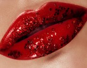 Beautiful closeup with female plump lips with gold color makeup. Fashion celebrate make-up, glitter cosmetic. Shine christmas style. Metalic makeup — Stock Photo