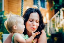 Girl feeding mother with berries — Stock Photo