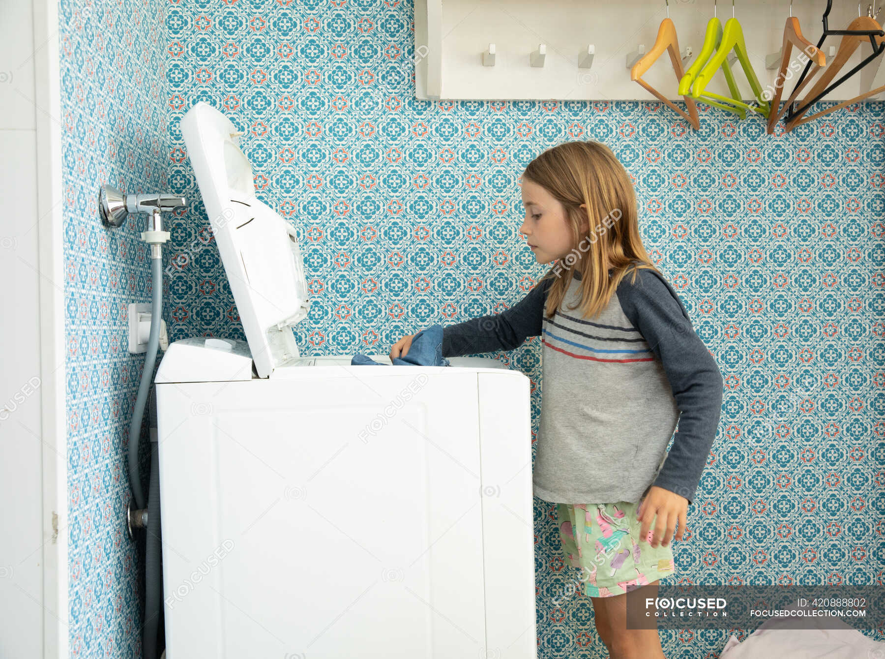 little-girl-helping-with-laundry-in-helsinki-finland-blond-hair