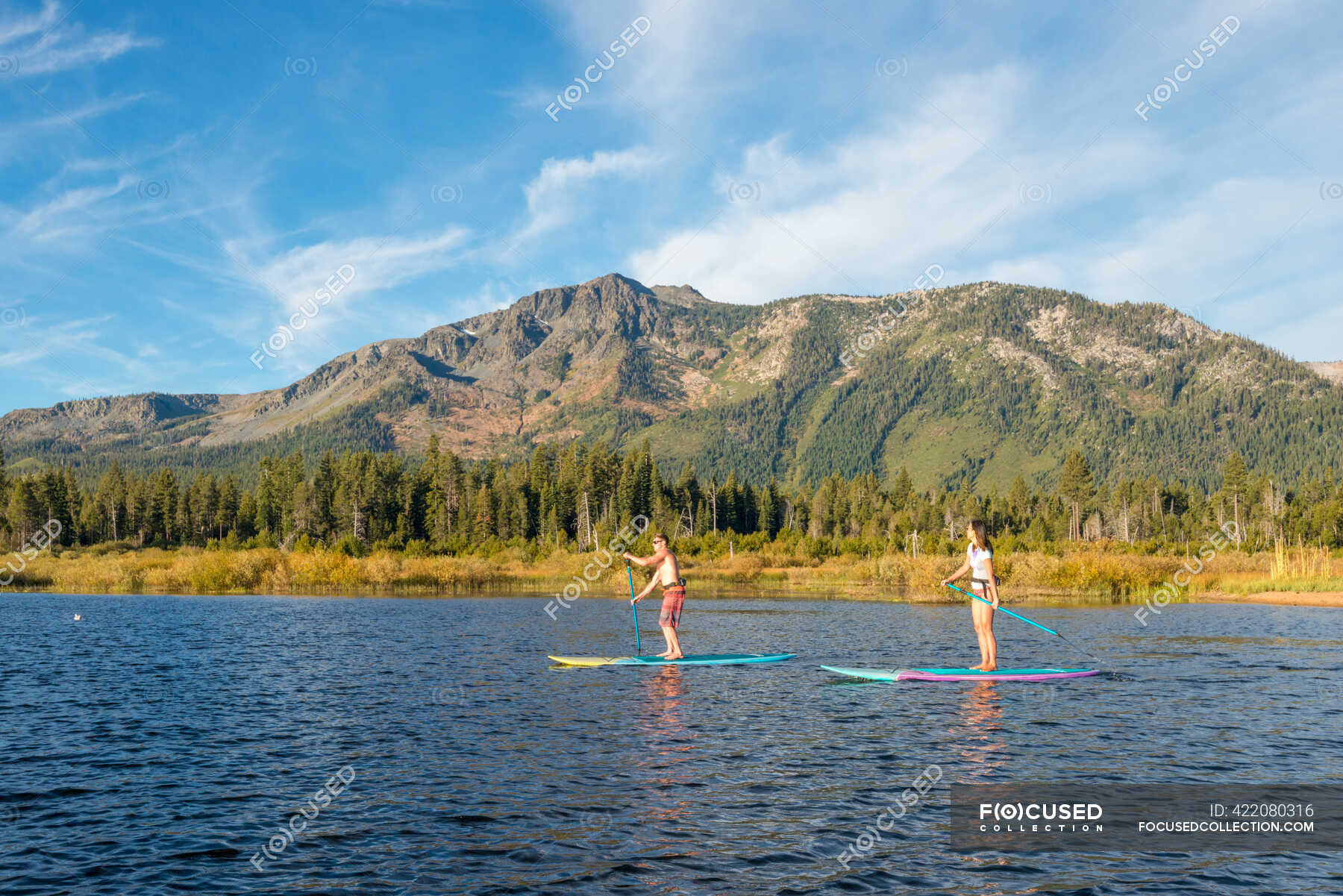 Stand up paddle boarding on Lake Tahoe next to Mount Tallac, CA