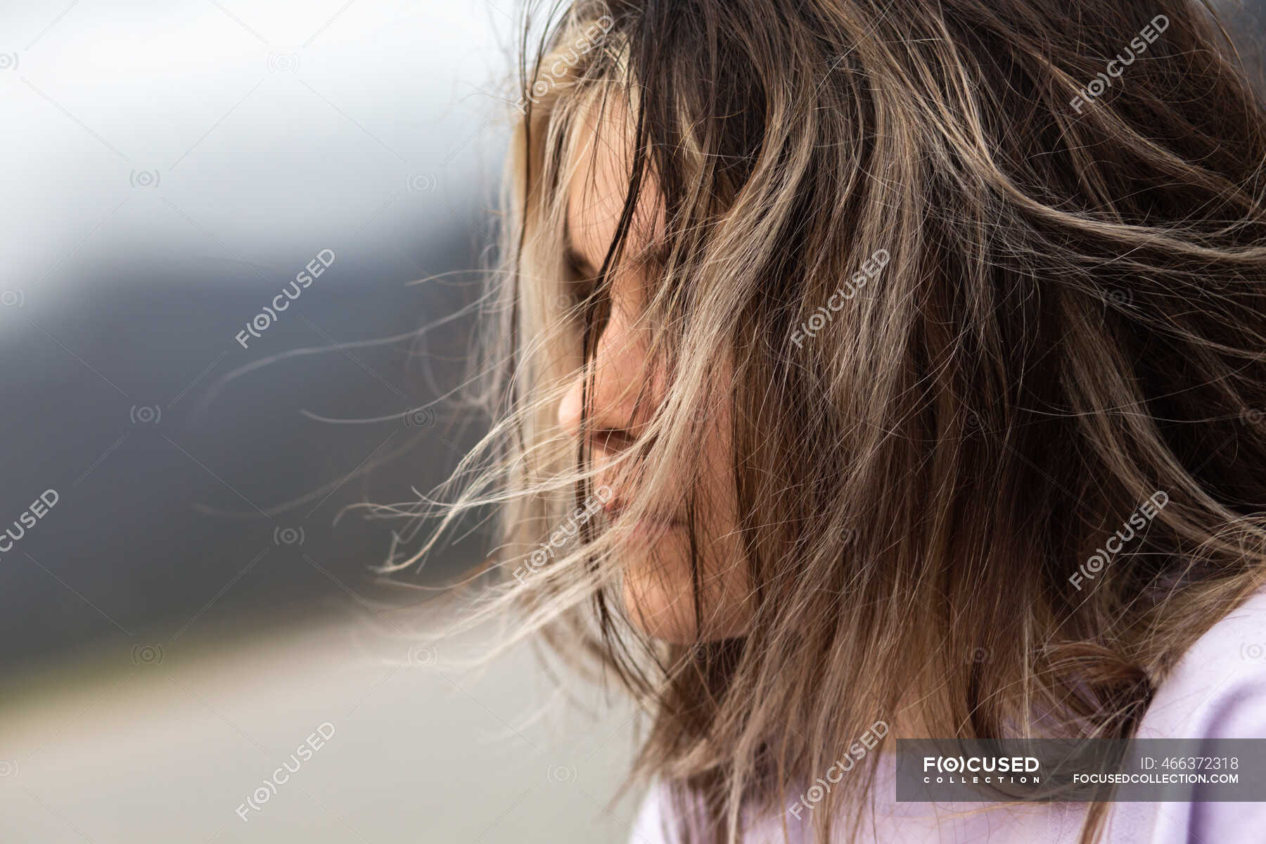 Young girl's hair blowing in the wind — white, nose - Stock Photo |  #466372318