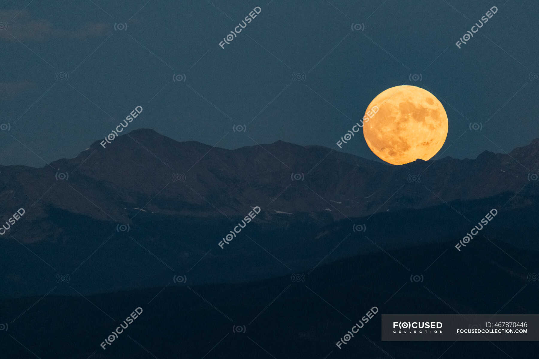 Idyllic Shot Of Full Moon Over Mountain Range Against Clear Sky At Dusk