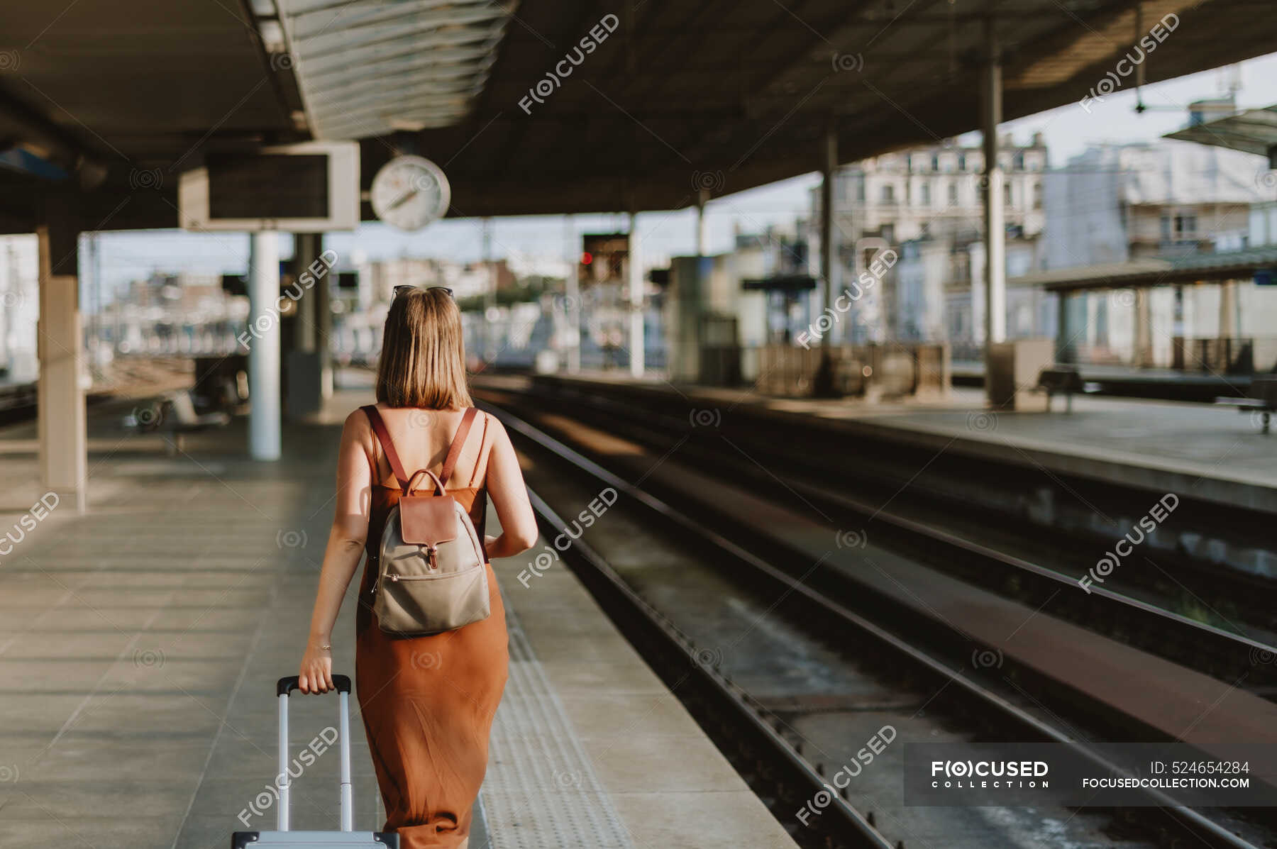 Young woman with suitcase at railway station — passenger, lifestyle ...