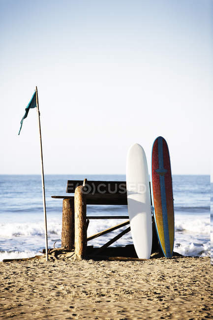 Surfboards lean against a bench between surf sessions at Stinson Beach, California — Stock Photo