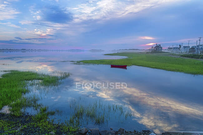 Beautiful sky reflects in coastal Maine inlet after sunrise. — Stock Photo