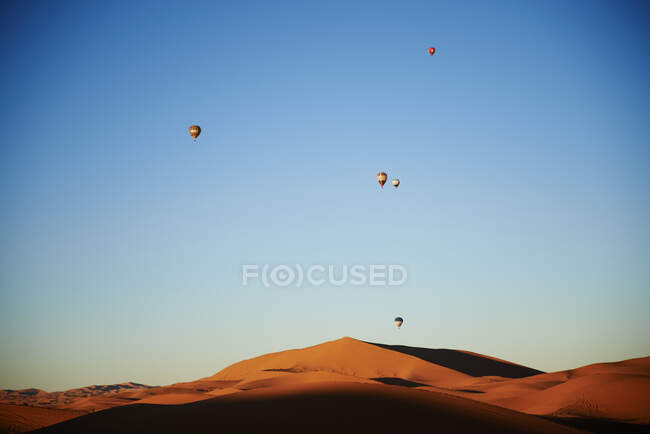 Hot air balloons over the dunes of the merzouga desert — Stock Photo
