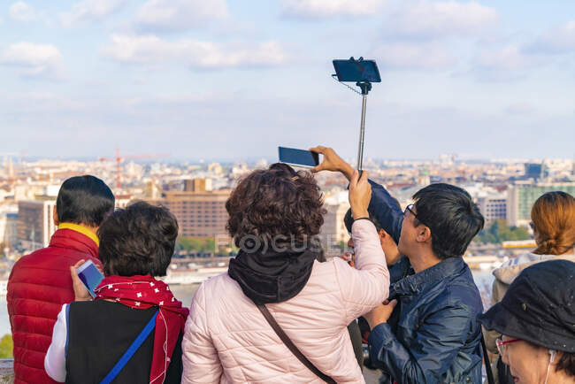 Asian tourists taking images of Budapest from the Buda castle — Stock Photo